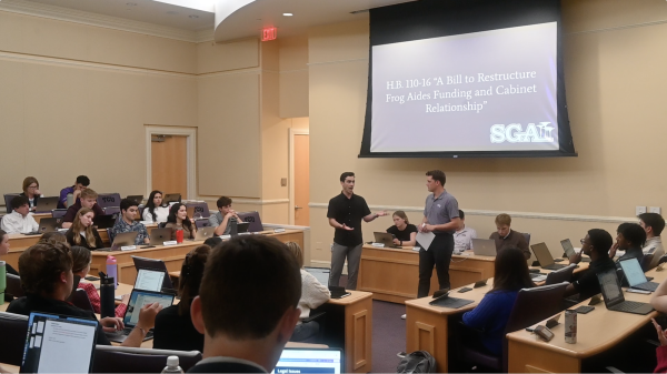 Student Body President Joe Winick and Chief of Staff Ash Harris present H.B. 110-16 to cut Frog Aides funding at the SGA meeting on April 9, 2024. (Ella M. Mercer/Staff Photographer)